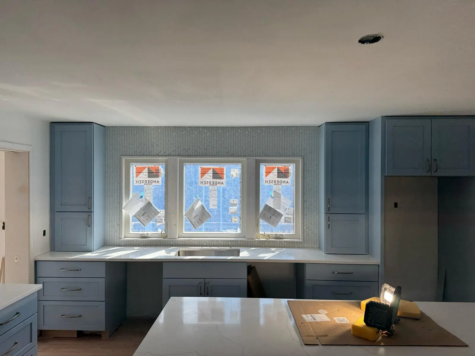Shaker-style custom cabinets with brass hardware in DC kitchen