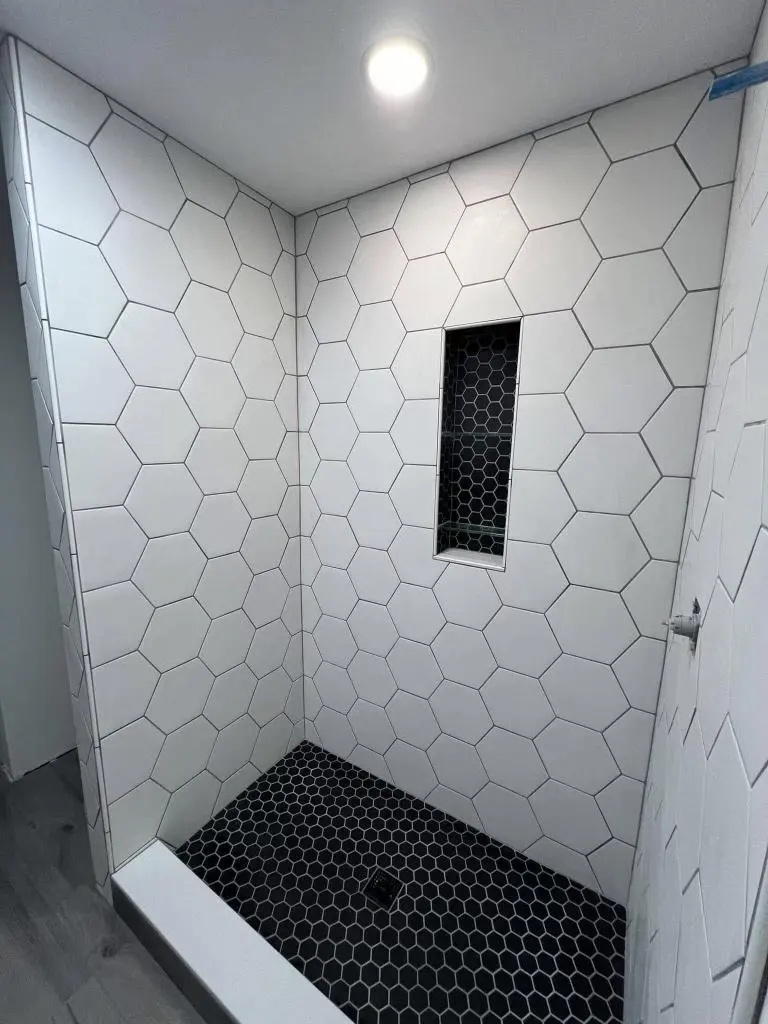 Bookmatched marble shower wall installation in Virginia bathroom
