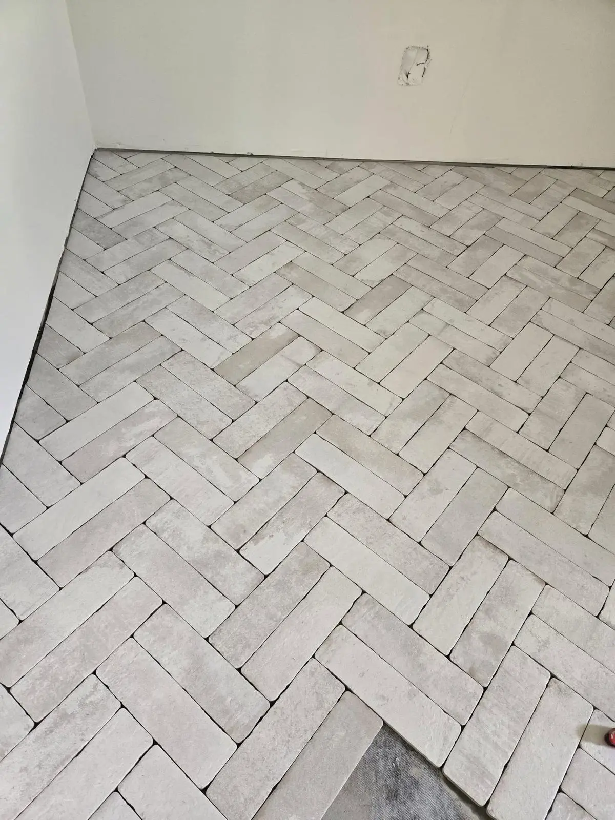 Herringbone porcelain tile floor pattern in Virginia bathroom